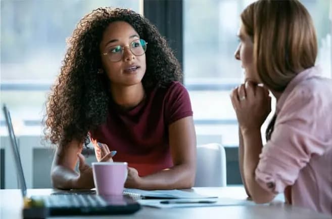 Two women talking in a coworking space