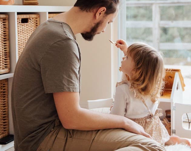 A parent and young child spending time together at home